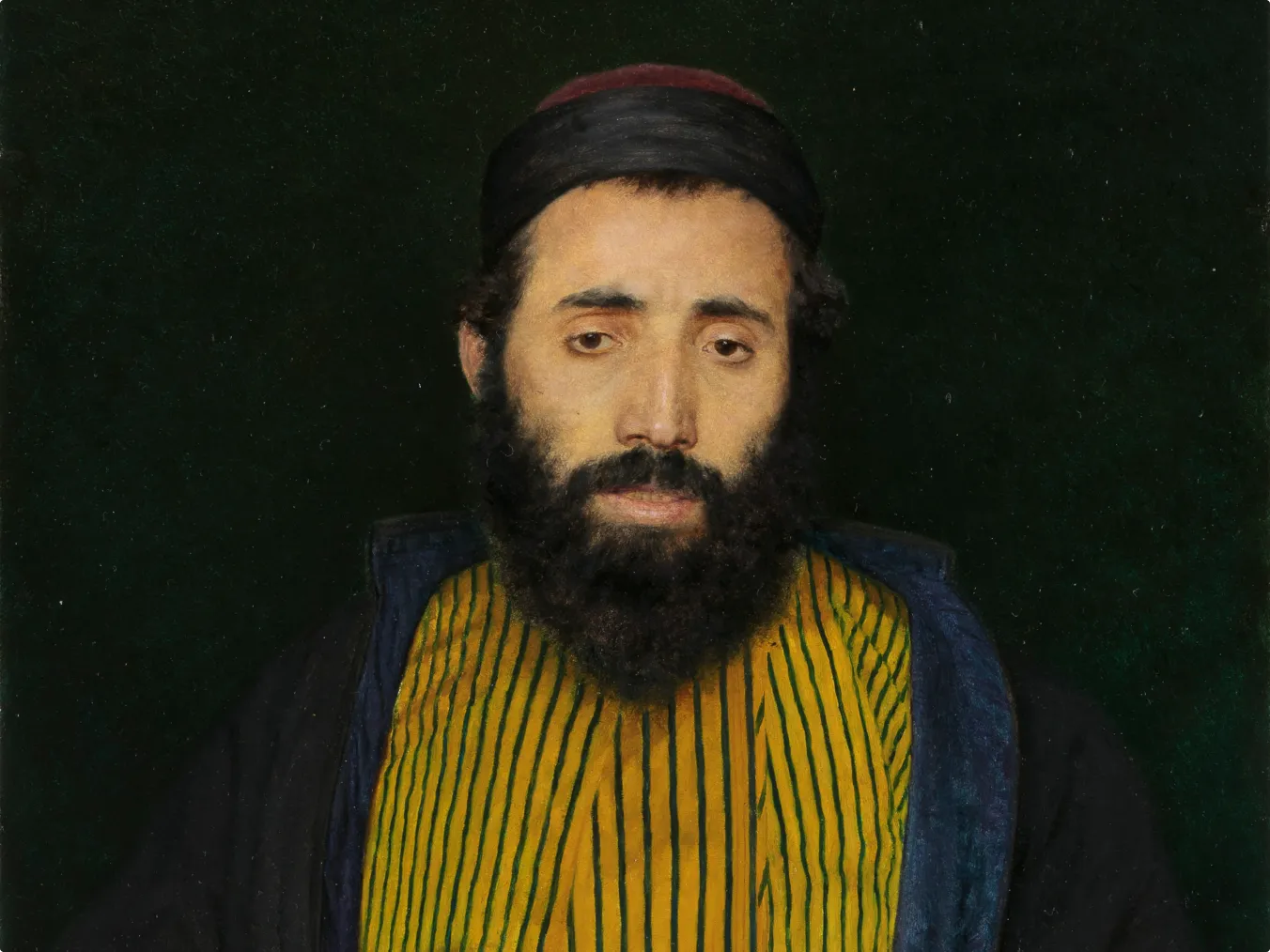 Portrait of a bearded man wearing a dark cap, a yellow garment with vertical green stripes, and a dark outer robe, set against a solid dark green background.