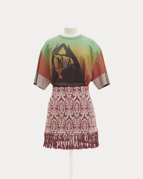 Mannequin dressed in a multicolored gradient T-shirt with black silhouette graphic and 