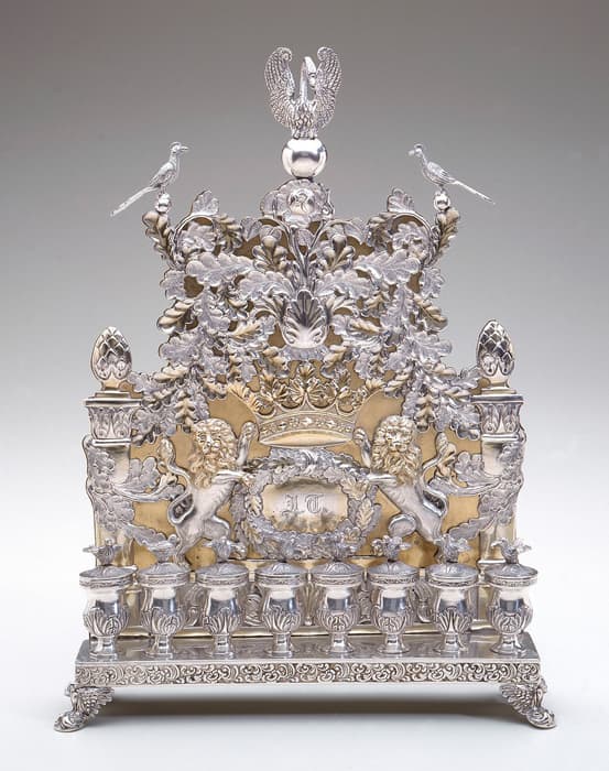 Hanukkah Lamp, Maciej Nowakowski (active 1825–1856), Warsaw (Poland), 1825-51, silver: repoussé, appliqué, parcel-gilt, and cast; copper alloy, 13 3/4 x 13 x 2 7/8 in. (34.9 x 33 x 7.4 cm). The Jewish Museum, New York. The Rose and Benjamin Mintz Collection, M 438
