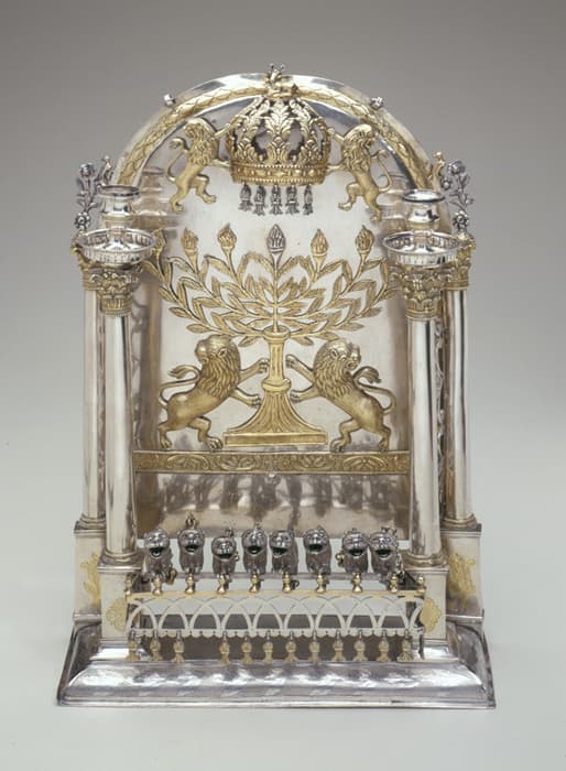 Hanukkah Lamp, Poland or Russia, early 19th century, silver: repoussé, parcel-gilt, appliqué, and cast, 18 1/4 x 12 13/16 x 4 3/4 in. (46.4 x 32.5 x 12.1 cm). The Jewish Museum, New York. Gift of Dr. Harry G. Friedman, in memory of Dr. Paul Romanoff, F 1965