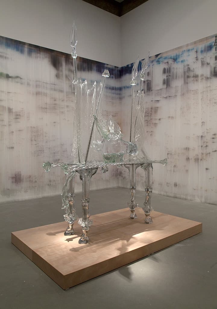 Izhar Patkin, The Messiah's glAss, 2003-7, glass and steel; You Tell Us What to Do Act II (detail), 2010-12, ink on pleated illusion, painting for four walls. Installation at the Tel Aviv Museum of Art, Israel, June 2012. Courtesy of the artist © Izhar Patkin. Photo: Yasimin Kunz