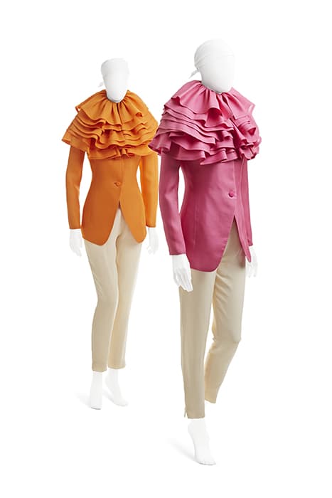 Blossom Blazers, double-silk gazar jackets with ruffle collar, silk crepe pants, spring 1991. Photograph © Jason Frank Rothenberg. “I tried to take the silliest things, like ruffles, and toughen them up,” Mizrahi notes. Here, ruffles are writ large, recalling the Elizabethan ruff and giving structure to a decorative element. The jacket was produced in pink, orange, or aquamarine. The aim was to turn a daywear blazer into an article of evening dress.”