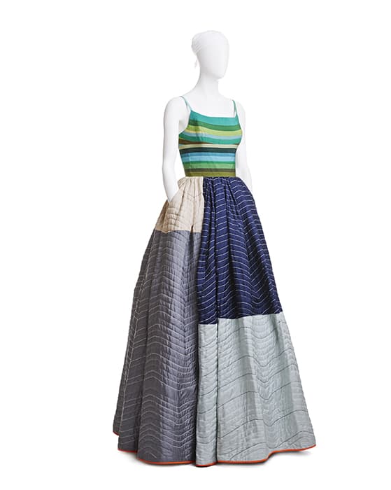 Elevator Pad Gown, grosgrain-ribbon bodice, quilted silk and lamb’s-wool skirt, spring 2005. Photograph © Jason Frank Rothenberg. Workhorse elevator padding used by movers inspired Mizrahi. He appropriated the quilting technique, but elevated the shipping blanket in a patchwork of blue, green, gray, and silver silk. The bodice was shaped from grosgrain ribbons, using heat molding.