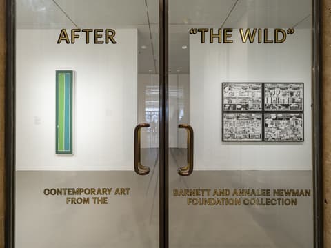View through glass doors into an art gallery exhibition titled AFTER 