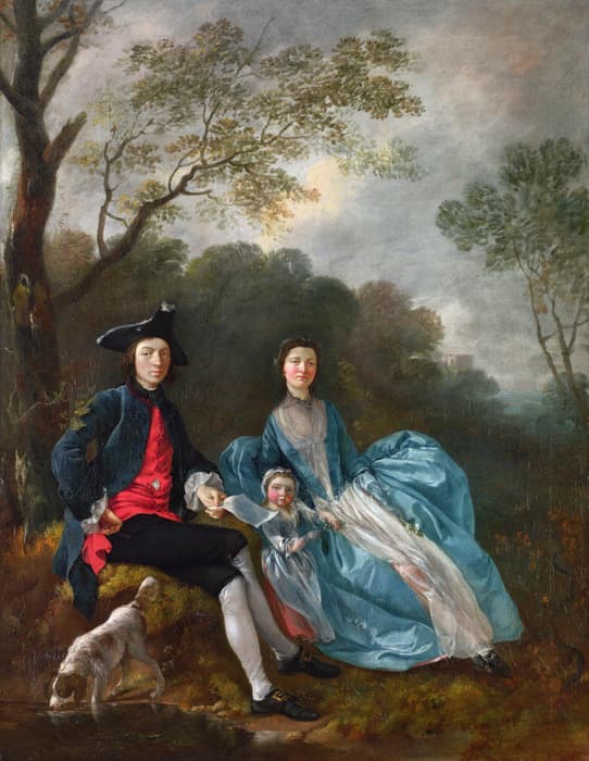An 18th-century family portrait set outdoors. A man, woman, and child sit beneath tall trees with dense foliage in the background. The man, wearing a dark coat, red waistcoat, white stockings, and a black tricorn hat, sits on a rock with one hand on his hip. The woman sits beside him, elegantly dressed in a voluminous blue gown with a sheer scarf and holding flowers. The child, also in blue, sits between them. A small dog sniffs the ground near the man's foot. The landscape features a cloudy sky and distant classical architecture.