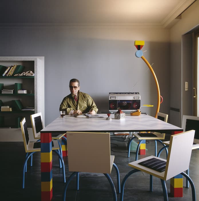 Karl Lagerfeld in his Monaco apartment, c. 1981. Ettore Sottsass, Suvretta bookcase. George James Sowden, Unknown table. Michele De Lucchi, Riviera chairs. Ettore Sottsass, Treetops floor lamp. Photograph © Jacques Schumacher 