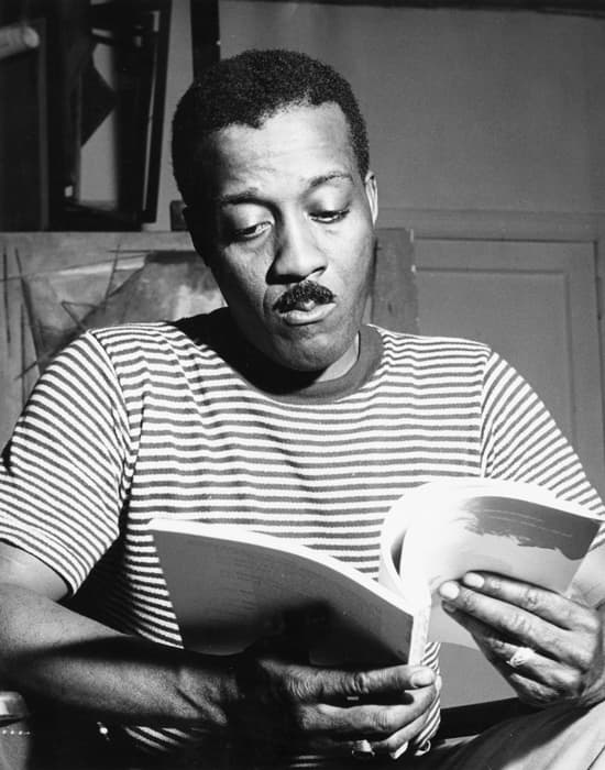 Norman Lewis reading, c. 1945, Willard Gallery Archives, courtesy of Miani Johnson.

Lewis was a largely self-taught artist. Though he briefly studied with Raphael Soyer, he rejected formal study. Lewis built up a library of art books, educating himself on everything from Persian prints to the art of El Greco through Cezanne, Modigliani, and Picasso. Self-study, though a slow and challenging process, secured him a degree of independence. Here, Lewis is seen in his studio likely reading a volume of Documents of Modern Art, a series edited by artist Robert Motherwell and published by George Wittenborn from 1944 – 1972.