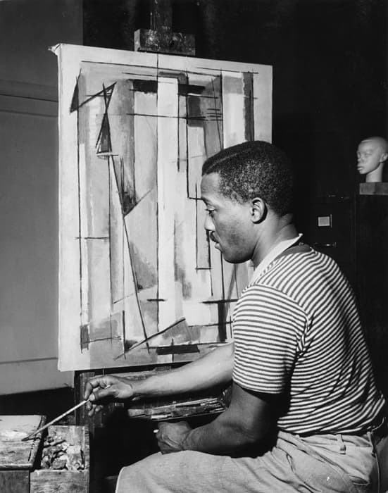 Norman Lewis painting (Composition I, 1945, Indianapolis Museum of Art), c. 1945, Willard Gallery Archives, courtesy of Miani Johnson.

In this image, Lewis is seen painting Composition I, currently in the collection of the Indianapolis Museum of Art. At the back right rests a sculpted head by William Artis—a student of Augusta Savage in whose studio Lewis also worked. By 1946, Lewis was immersed in abstract painting. Paintings like Composition I (1945), Phantasy II (1946) and Untitled (1949) are early examples of his work in abstraction, a style of painting that was uncharacteristic for an African-American artist at the time.