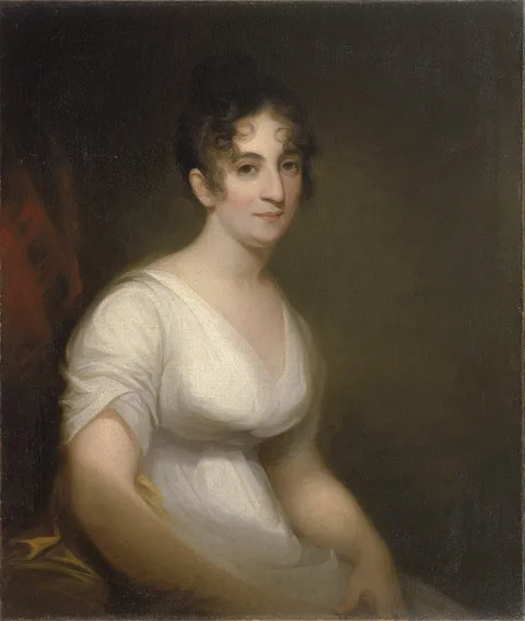 Oil painting portrait of a seated woman wearing a white empire-waist dress, with dark hair in curls, looking calmly at the viewer against a dark, neutral background.