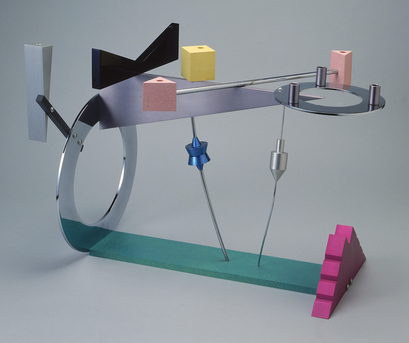 Whimsically-shaped, geometric menorah. Colorful, abstract objects are carefully balanced, almost like a mobile. It features a Star of David and a Dreidel shape.